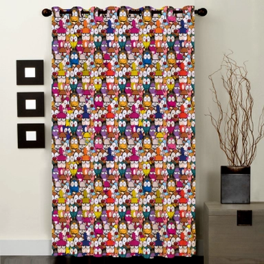 Colorful owl patterned curtain in a modern room with wall art and vase.