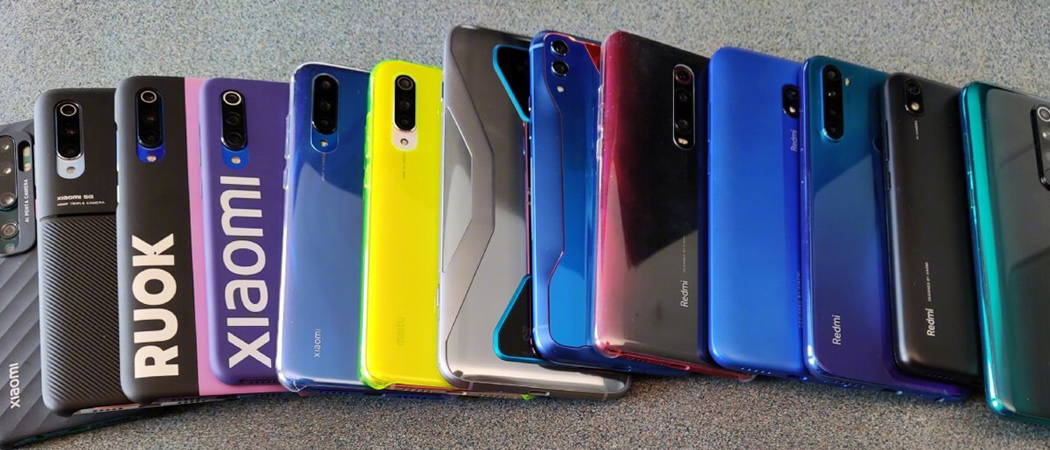Colorful Xiaomi and Redmi smartphones lined up on a table