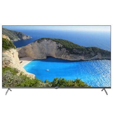 LED TV displaying a scenic beach with blue water and rocky cliffs.