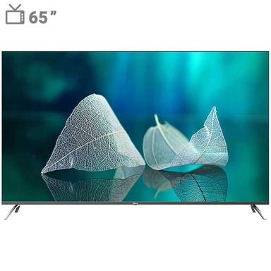 LED TV displaying a scenic beach with blue water and rocky cliffs.