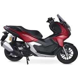 Red and black maxi-scooter motorcycle with windshield, side view on white background.