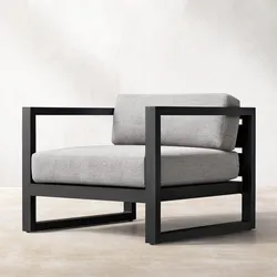 Modern black-frame armchair with light gray cushions on a neutral background.
