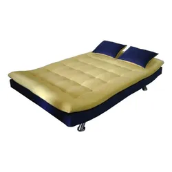 Modern low-profile bed with cream mattress and two navy pillows.