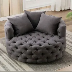 Round tufted gray lounge couch with two matching cushions.
