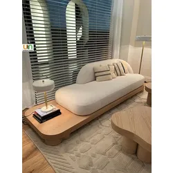 Modern minimalist cream sofa with wooden base in a stylish living room setting