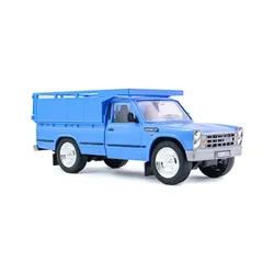 Blue toy pickup truck with open cargo bed and silver grille.